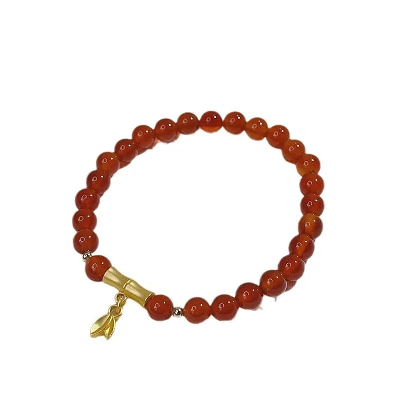 A red agate bracelet for women with a manual crafted dragon design in Chinese style.