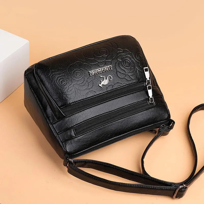 Black PU women's shoulder messenger bag with horizontal square shape, single strap, slit pocket, and phone bag