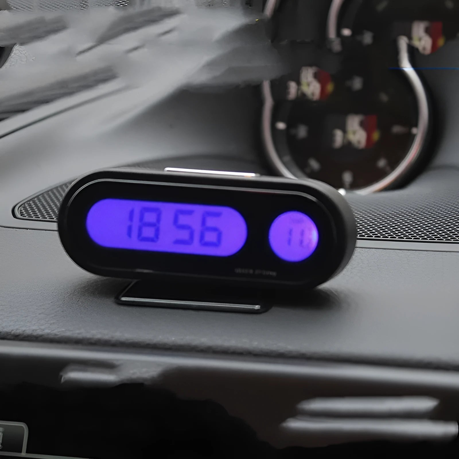 Black car electronic clock and thermometer with LED display on an adjustable dashboard bracket.