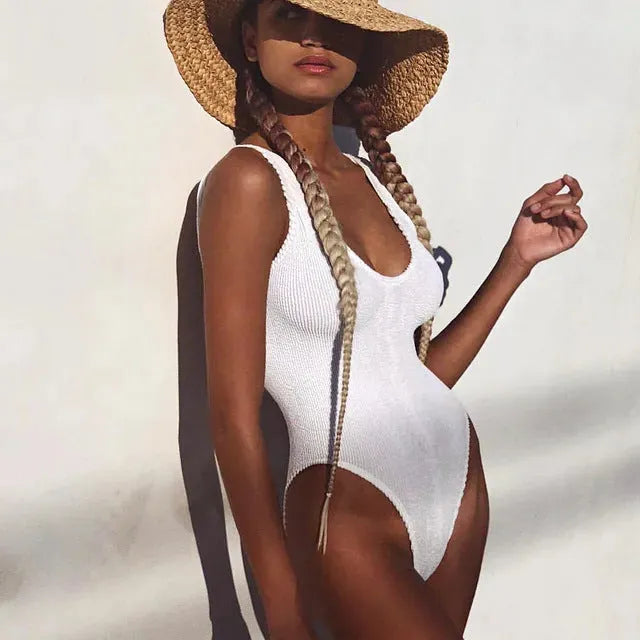 Women's solid colour one-piece swimsuit with wrinkled seersucker fabric in a backless, sleeveless design.