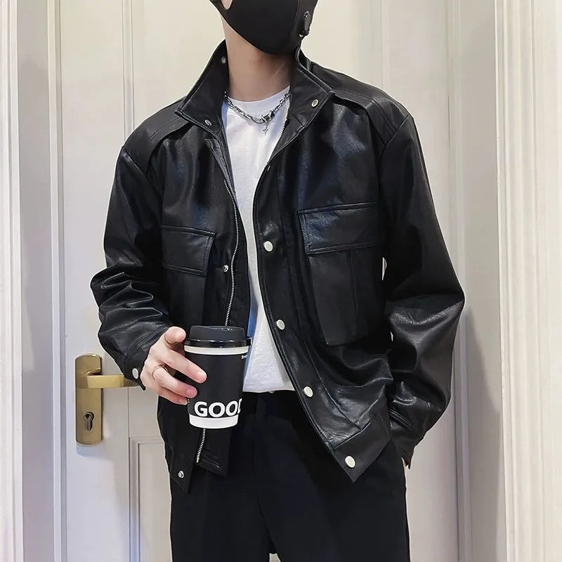 Men's black Korean style PU leather jacket with side pockets and straight hem on a hanger.