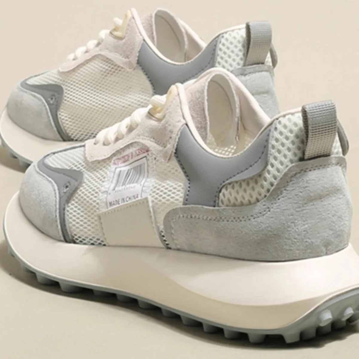 Women's grey and pink low-top retro sneaker with round toe and flat rubber sole