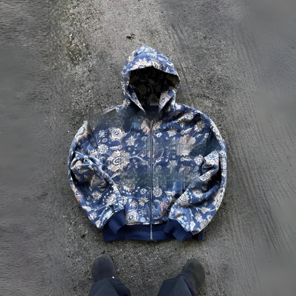 Man wearing a blue loose-fit hooded zip coat with long sleeves and digital printing.