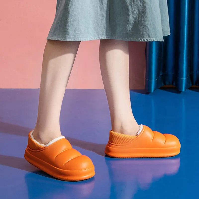 A pair of waterproof EVA couple slippers in various colours, showing plush lining and a non-slip sole.