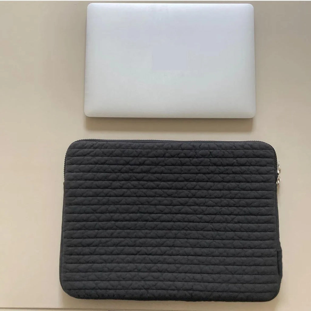Black and white cotton cloth clutch-style laptop bag with internal coin pocket for anti-seismic tablet protection.