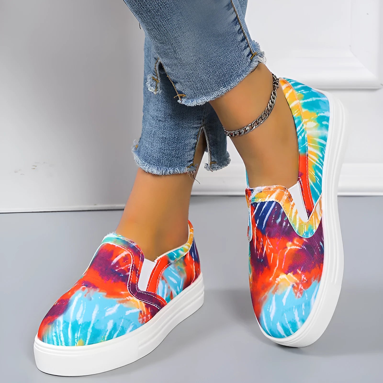 Women's blue low-top canvas sneaker with flat rubber sole on a plain background.