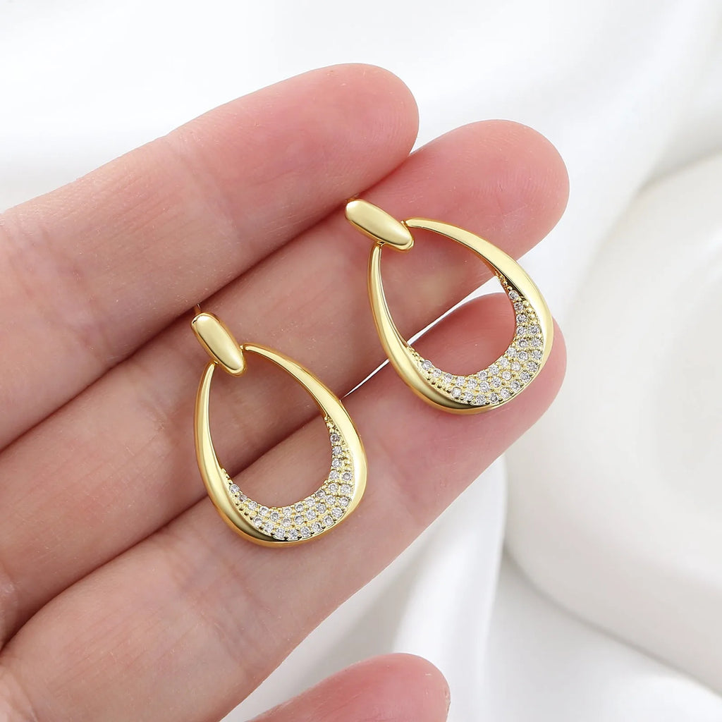 Women's yellow gold geometric drop earrings with ring and oval elements measuring 2.6 by 1.7 cm