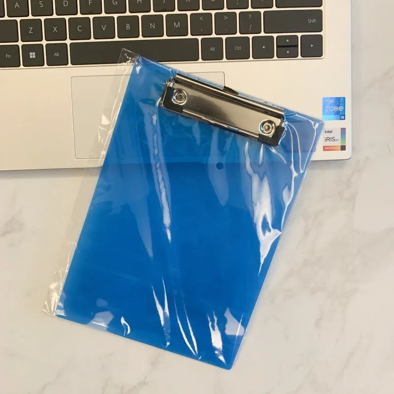 A4 transparent polypropylene clipboard with metal clip, shown in blue, holding paper.
