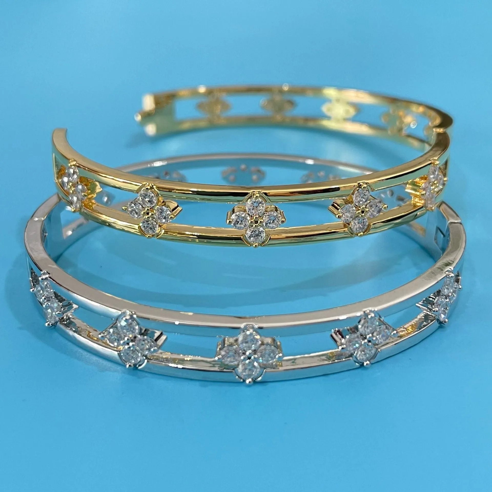 Gold and silver hollow women's bracelets with four-leaf clover charm and zircon stones.