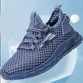 Men's beige casual sneakers with synthetic leather upper and mesh detailing, showing lace-up front and low-profile EVA sole.