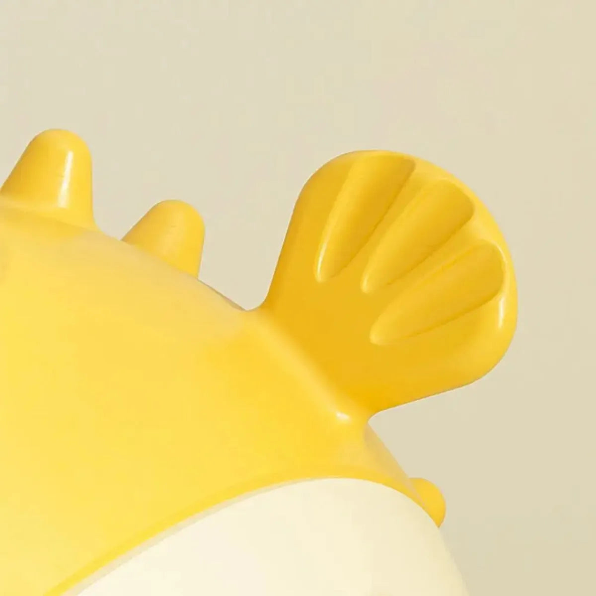 Yellow vinyl fish-shaped dog chew toy with textured surface for tough chewing and dental care.