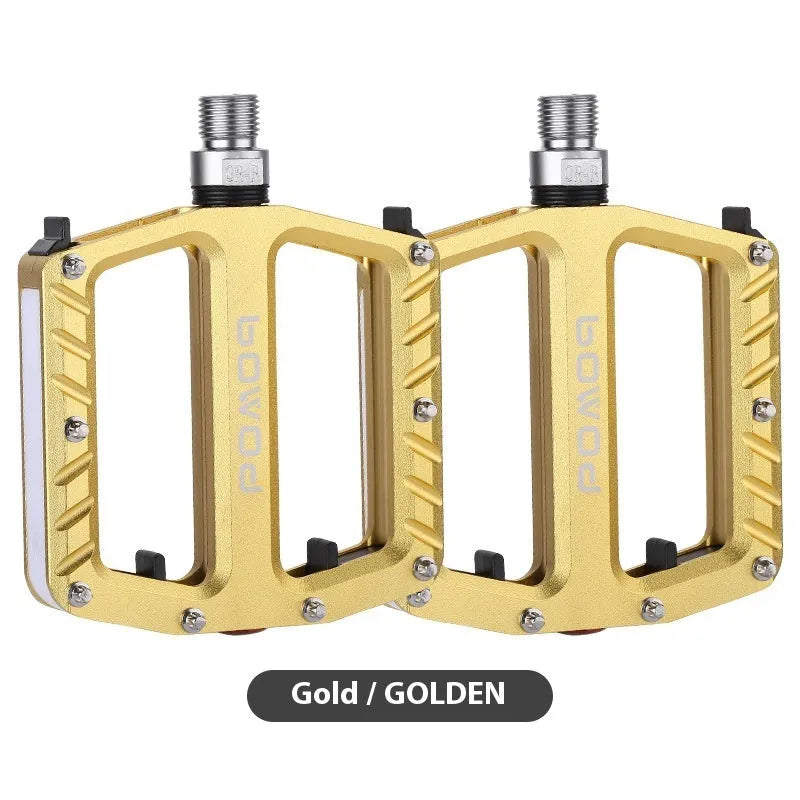 Aluminium alloy bicycle pedals with built-in 710LED lights in black, gold, purple, red, and titanium colour options.