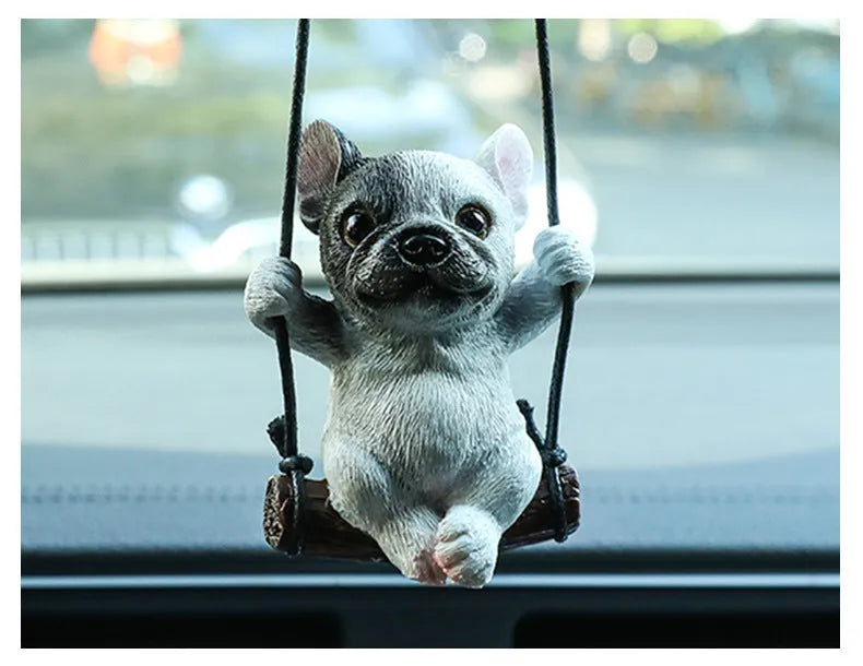 Cartoon-style resin bulldog car pendant hanging from a rearview mirror.