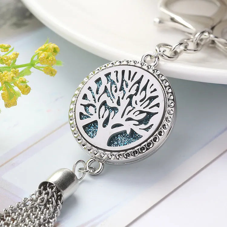 Alloy metal car fragrance pendant with tassel on a 50cm chain, shown with scented cotton pieces.