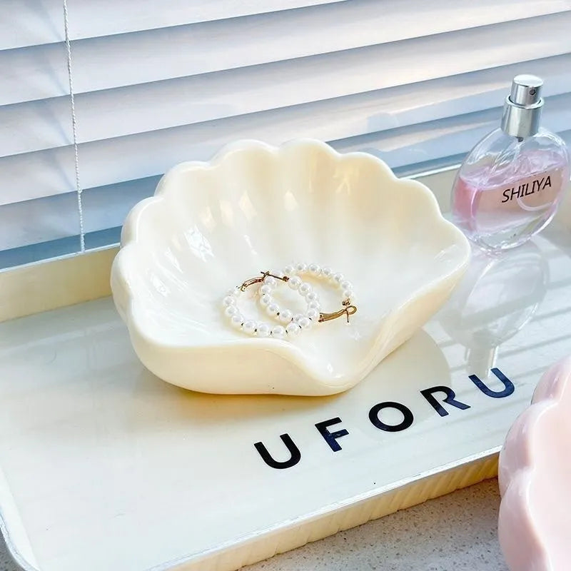 Plastic shell-shaped soap dish in pearl white colour for bathroom use