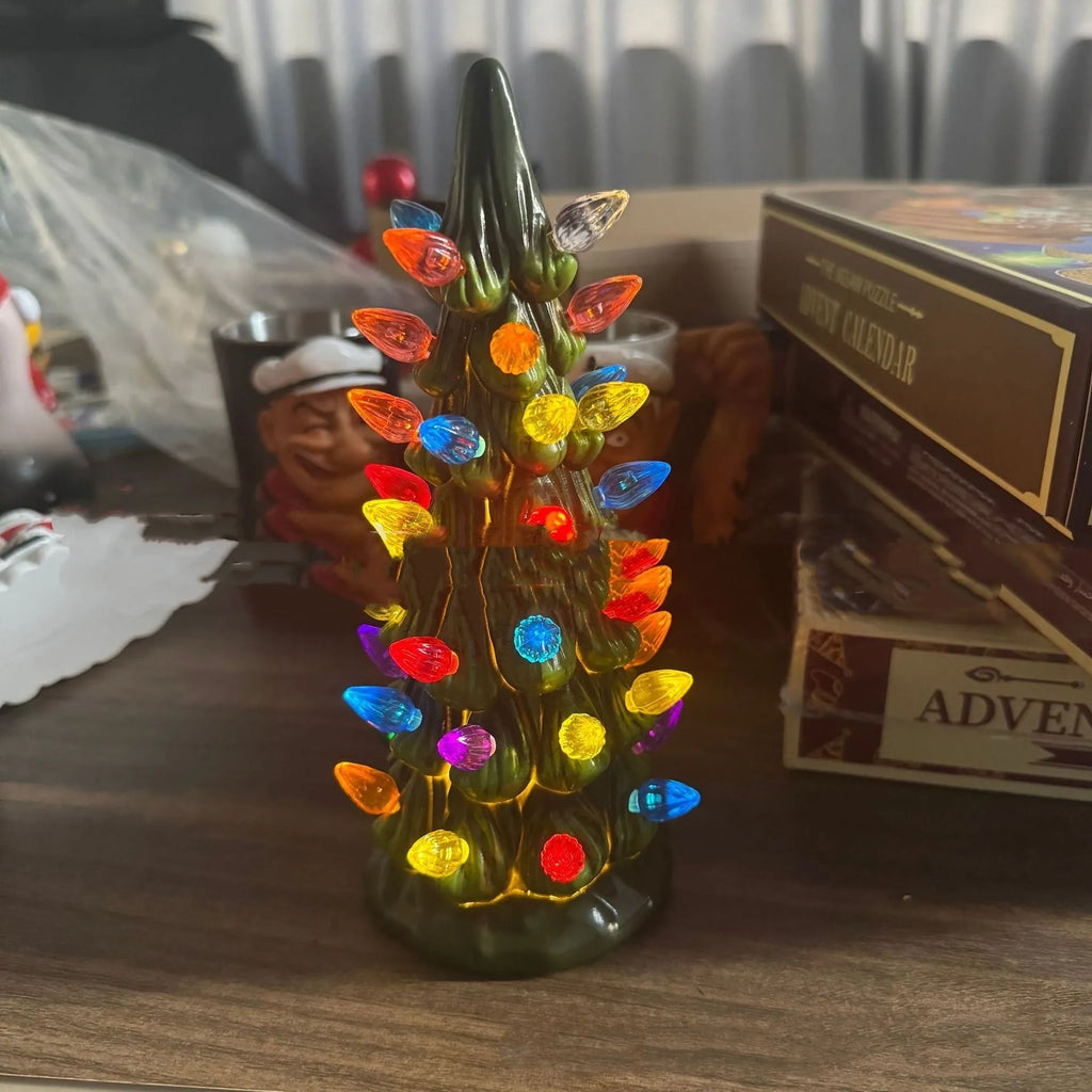 European-style resin Christmas tree decoration in various sizes with coloured or warm lighting options.