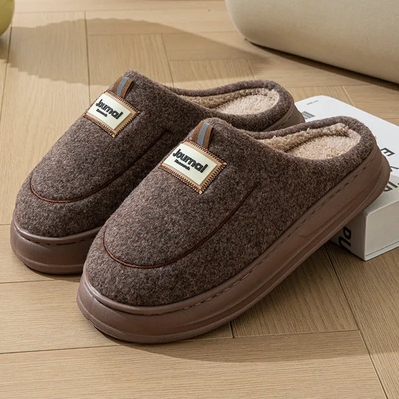 Men's brown suede slippers with thickened sole on wooden floor