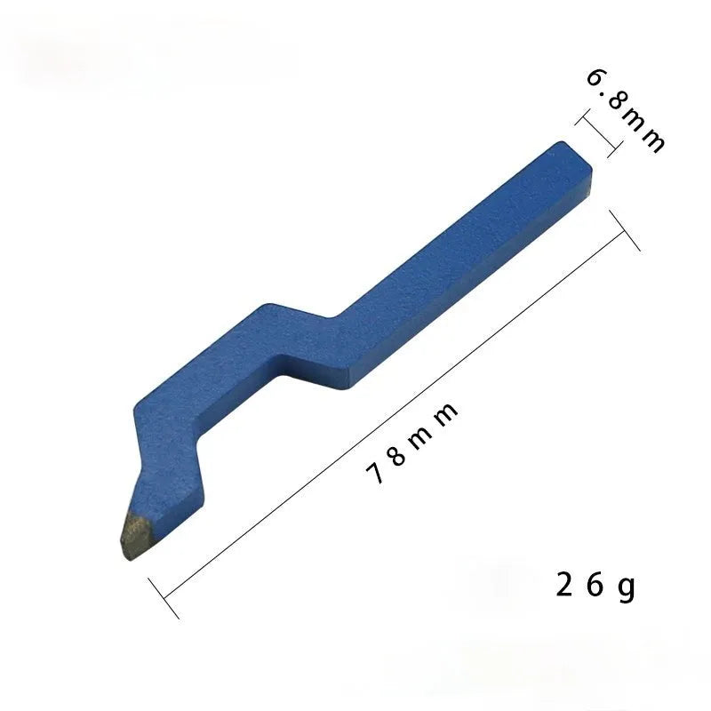 Curved alphanumeric steel stamping tool for jewellery on a metal surface.
