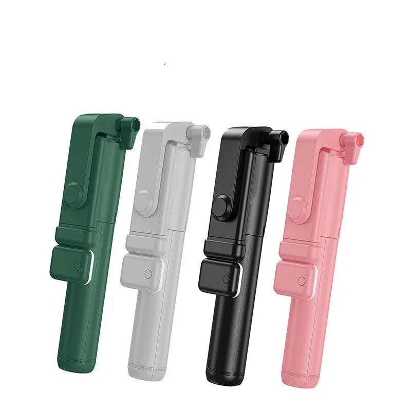 Black Bluetooth selfie stick with extended tripod legs holding an iPhone, showing its 360-degree rotating phone holder.