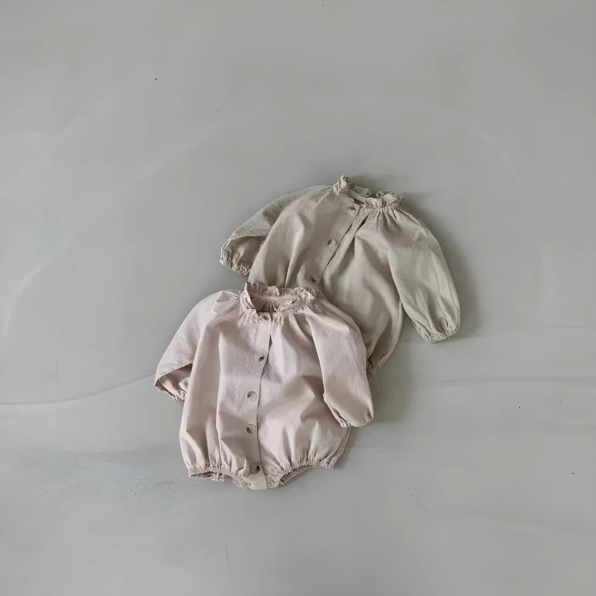 Baby cotton button jumpsuit romper in light lotus pink, long sleeves, wooden ear collar, suitable for 66-90cm height.