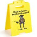 Yellow plastic humour desk decoration with simple modern design on a shelf