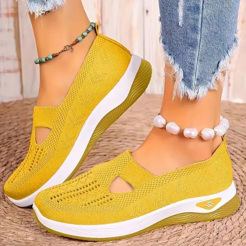 Women's light grey mesh casual flats with a T-strap and round toe on a soft PVC sole.