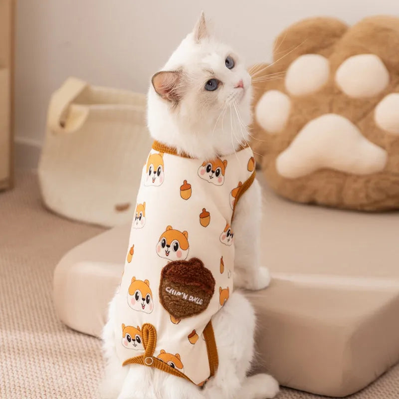 Chip 'n' Dale sleeveless dog jumpsuit with squirrel and acorn print, fuzzy embroidered acorn pocket, ribbed cuffs and snap closure, cream or white.