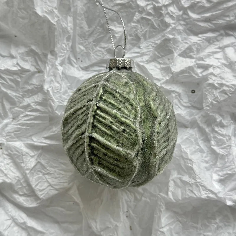 Handmade glass Christmas ball pendant 8cm in green colour hanging on tree branch