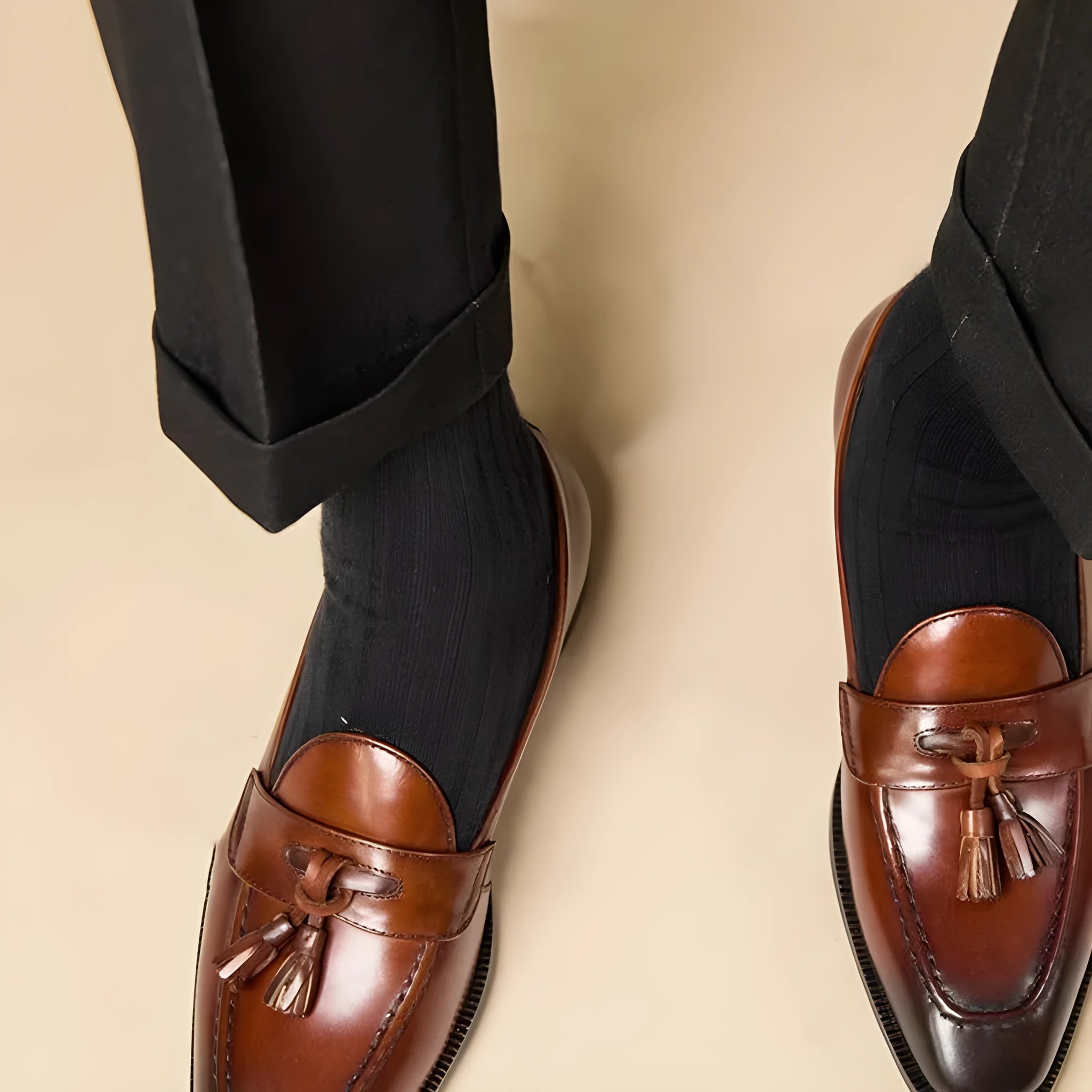 Black and brown business casual loafers with tassel detail and genuine leather upper