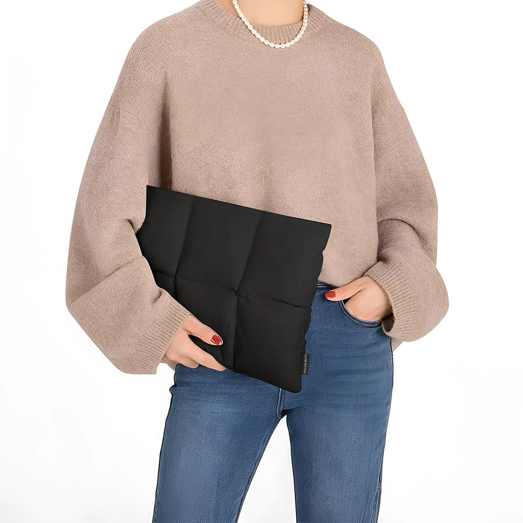 Black soft fluffy polyester laptop sleeve for 13 to 15.6 inch devices on a table