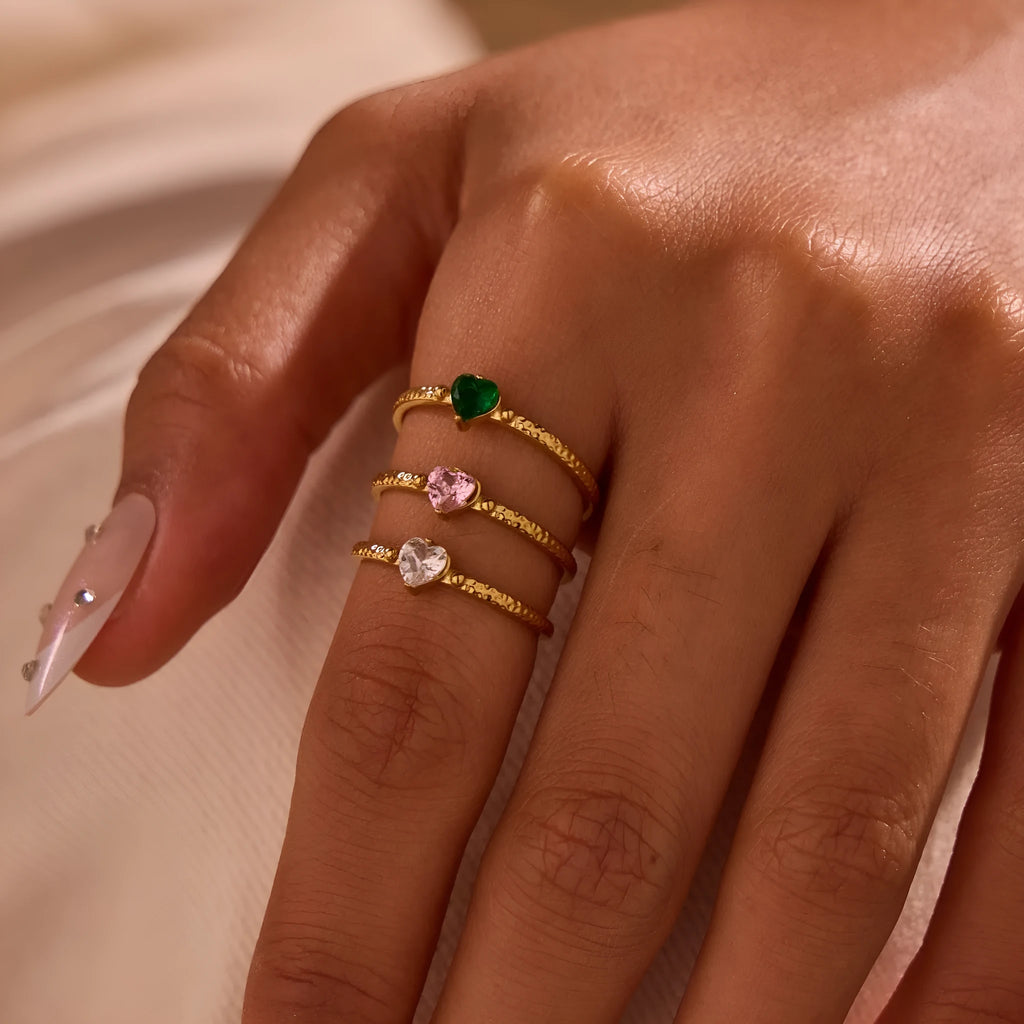 Open-ended stainless steel heart-shaped ring with inlaid zircon stones in green, pink, or white.