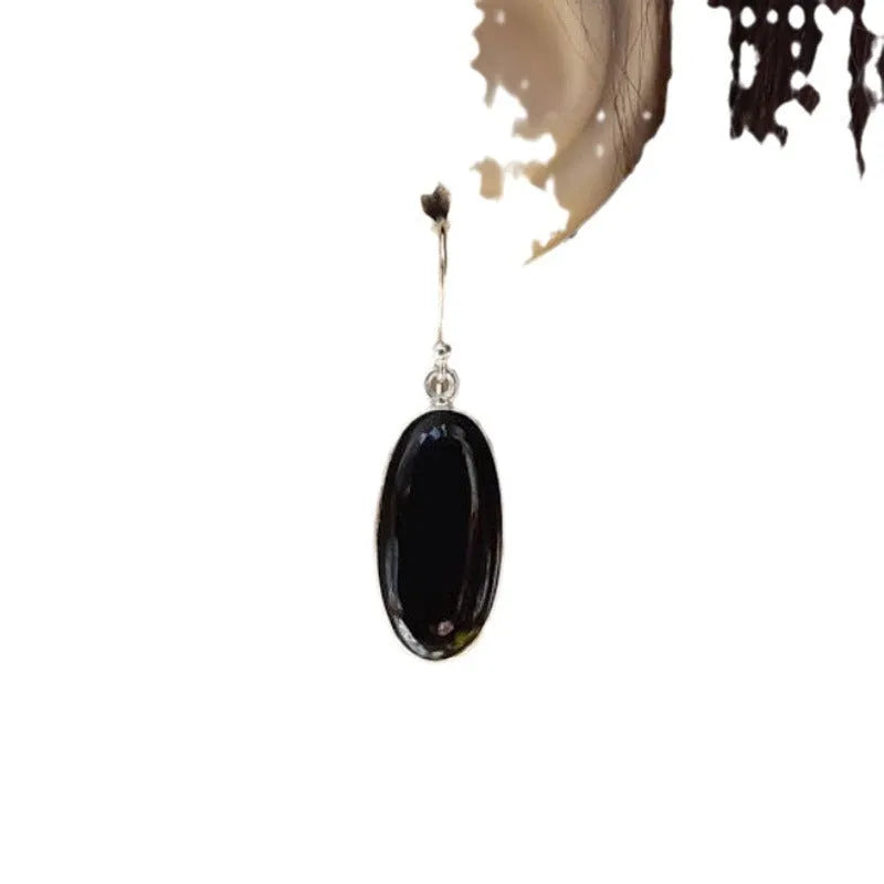 Women's geometric drop earrings with oval black agate pendant in silver setting
