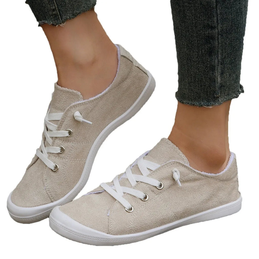 Women's low-top beige fabric casual sneakers on a white background.