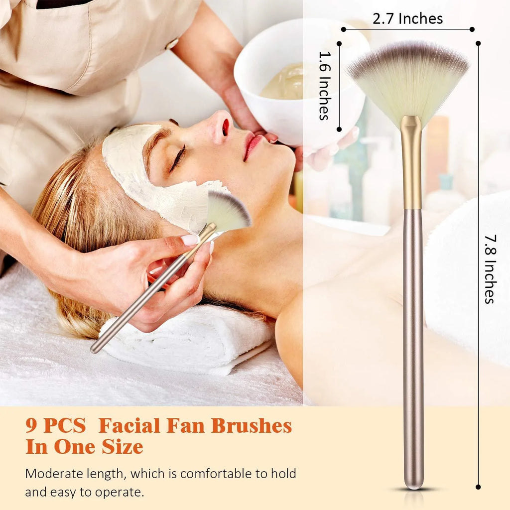 Ten champagne-coloured fan makeup brushes with soft fibre bristles and protective covers laid out.