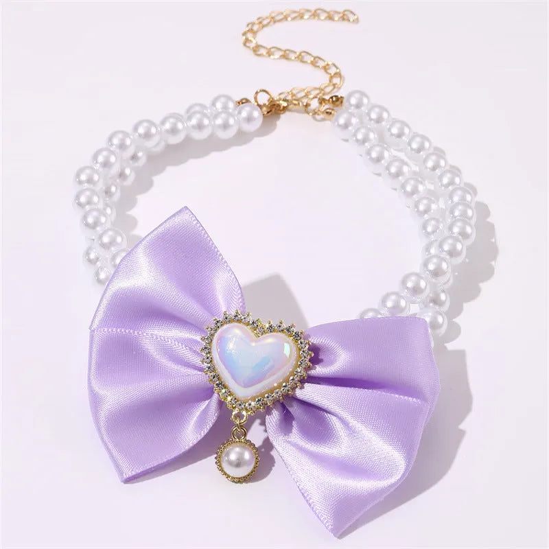 Heart shaped princess style pet necklace with pearl beads in pink on a white background
