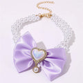 Heart shaped princess style pet necklace with pearl beads in pink on a white background
