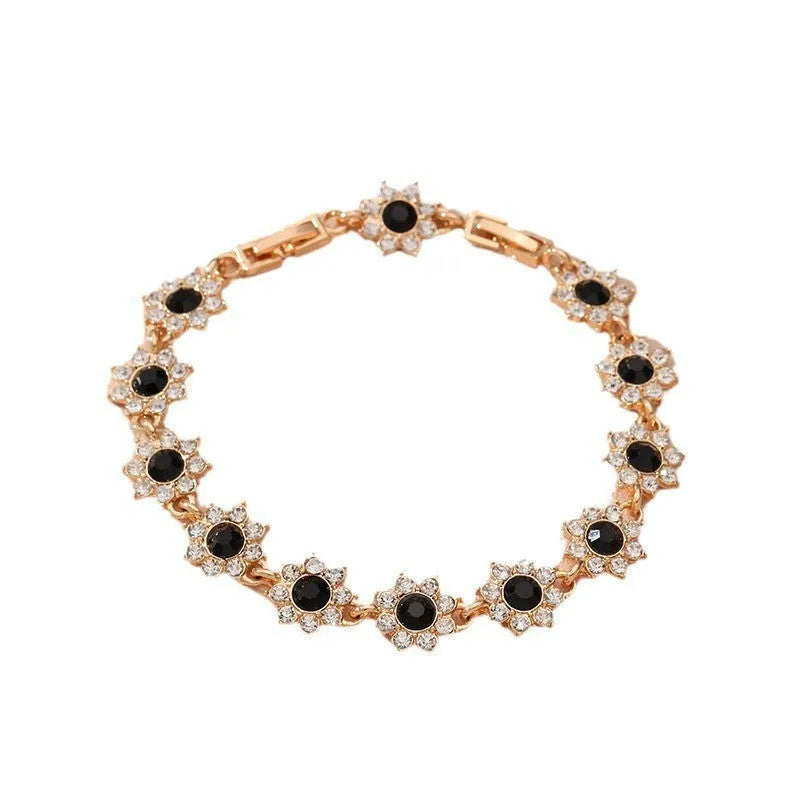 Electroplated zinc alloy floral bracelet showing colour variations including gold and silver tone options