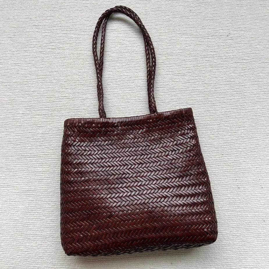 Woven vintage cowhide leather tote bag with three-dimensional outer pockets showing brown colour