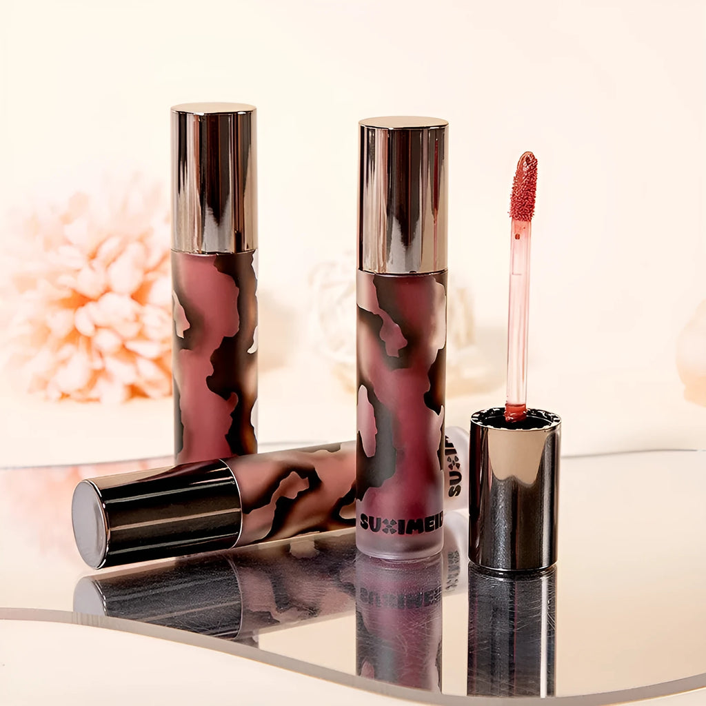 Matte lip mud lipstick in tube showing five colour shades: orange brown coffee, cool grey, cinnamon coffee, jujube red, smoked purple.