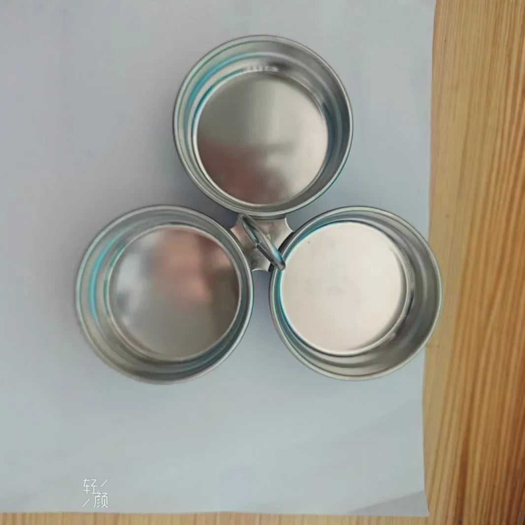 Stainless steel mini egg cooker with a heart-shaped mould and a round mould for steaming eggs.