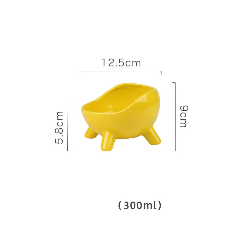 Green ceramic pet food bowl with four legs and wide mouth opening for cats and small dogs