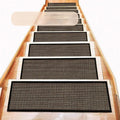 Japanese-style linen-look polyester stair mat in camel colour on a wooden step