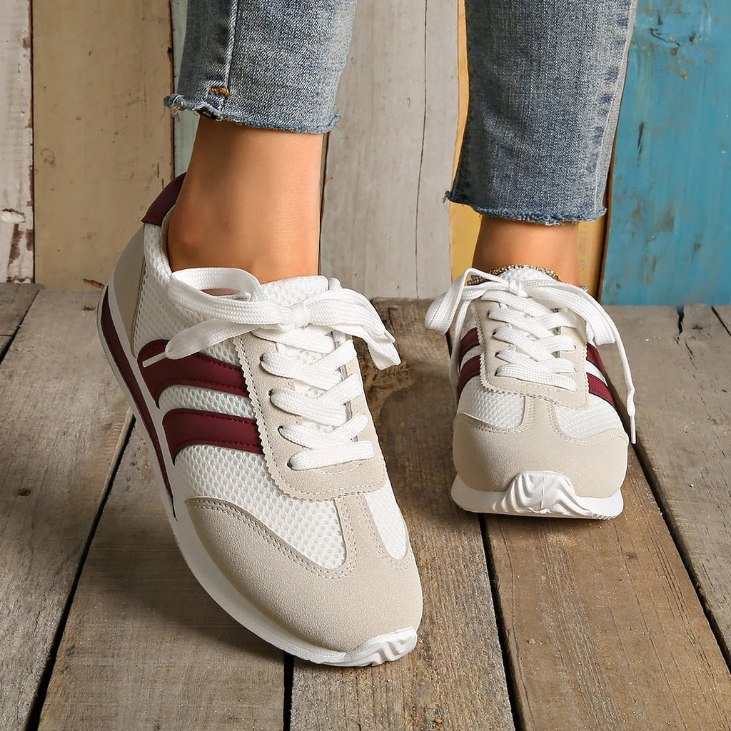Wine red Cortez Retro sneaker with mesh upper, cross strap, and flat rubber sole.
