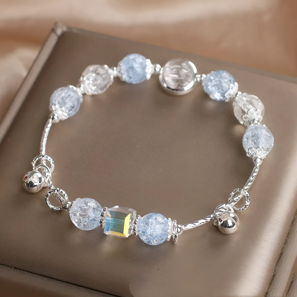 Light blue artificial crystal bell bracelet on woman's wrist