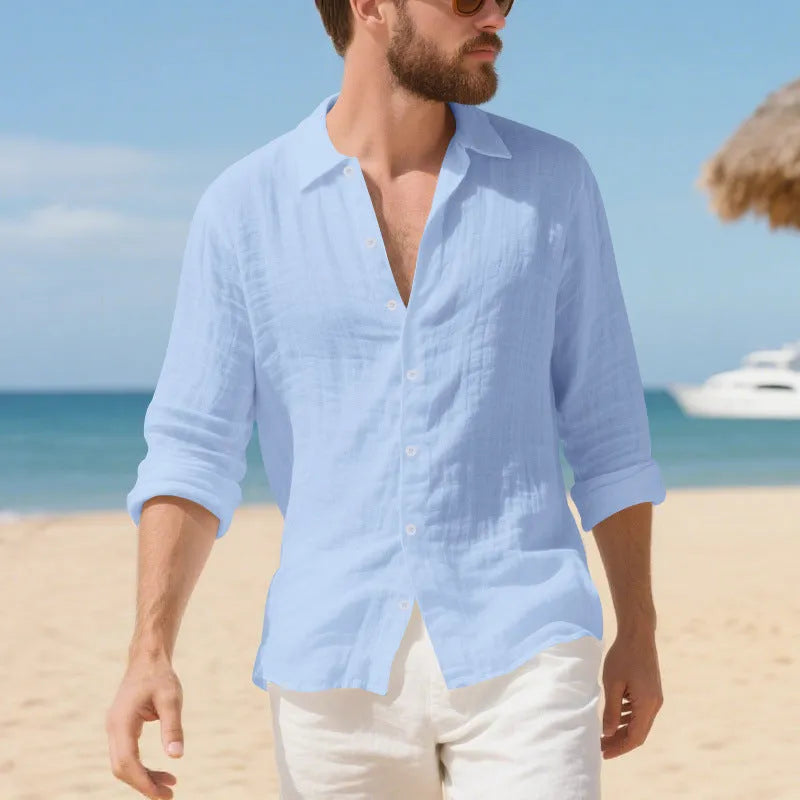 A man's loose-fit linen Hawaiian casual shirt in an earthy colour on a hanger.