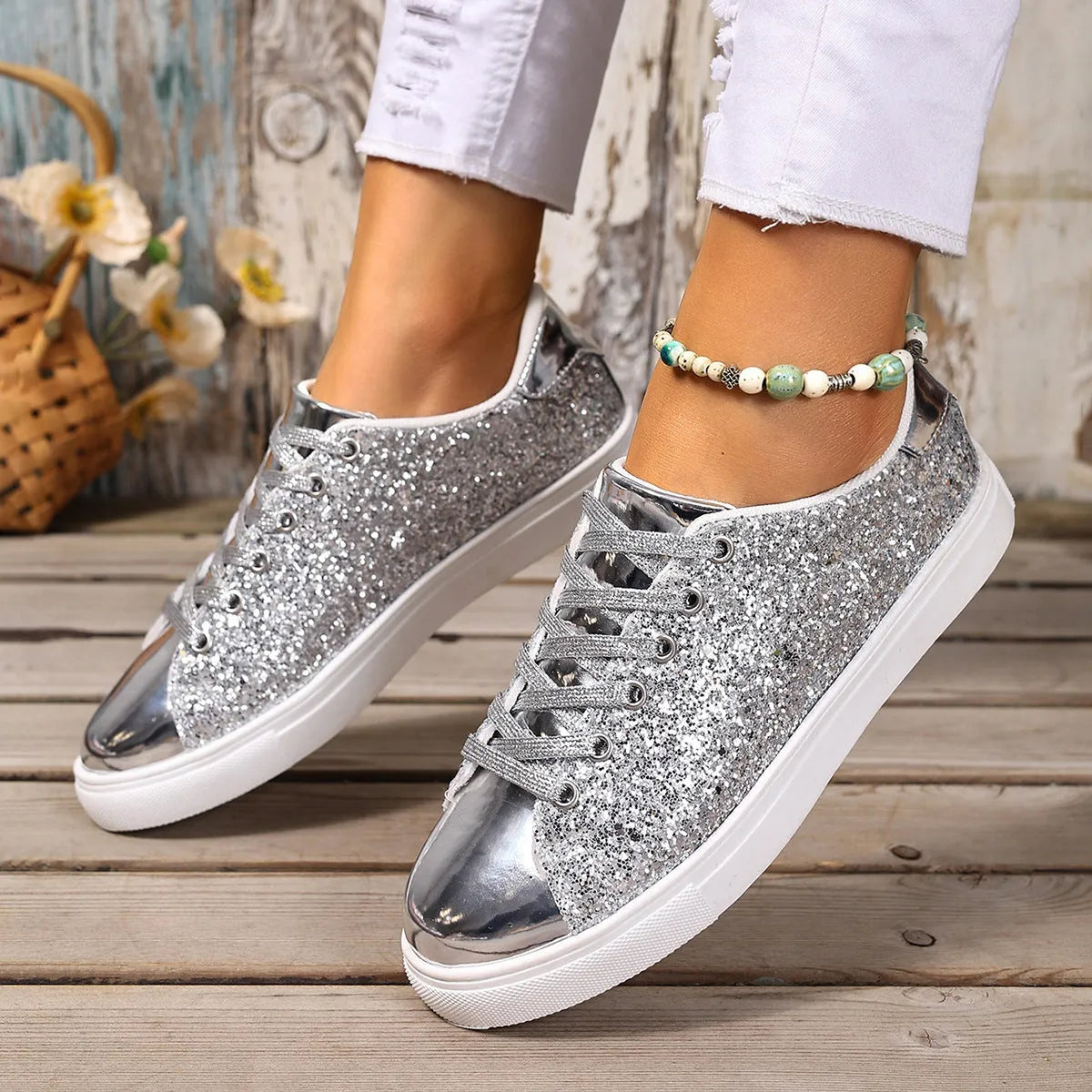 Women's plus size sequined board shoes in black with front lace-up fastening and flat rubber sole.