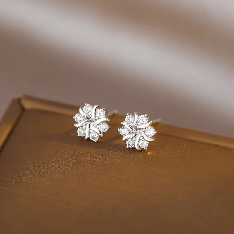 Silver snowflake ear stud earrings for women with zircon detail and copper base, geometric compact design.