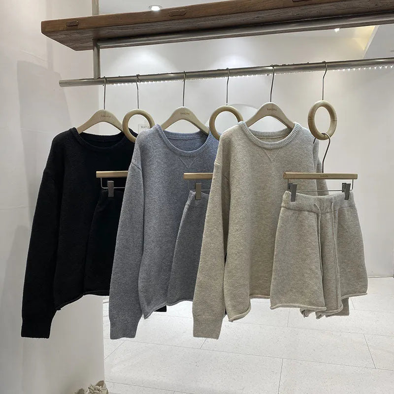 Women's knitted two-piece set showing loose-fitting long sleeve sweater and matching wide-leg shorts in neutral colour
