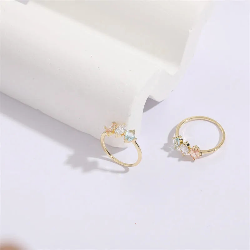 Geometric copper ring with a horse eye motif and tricolour zircon stone, electroplated in 14K Real Gold RG9066 colour.