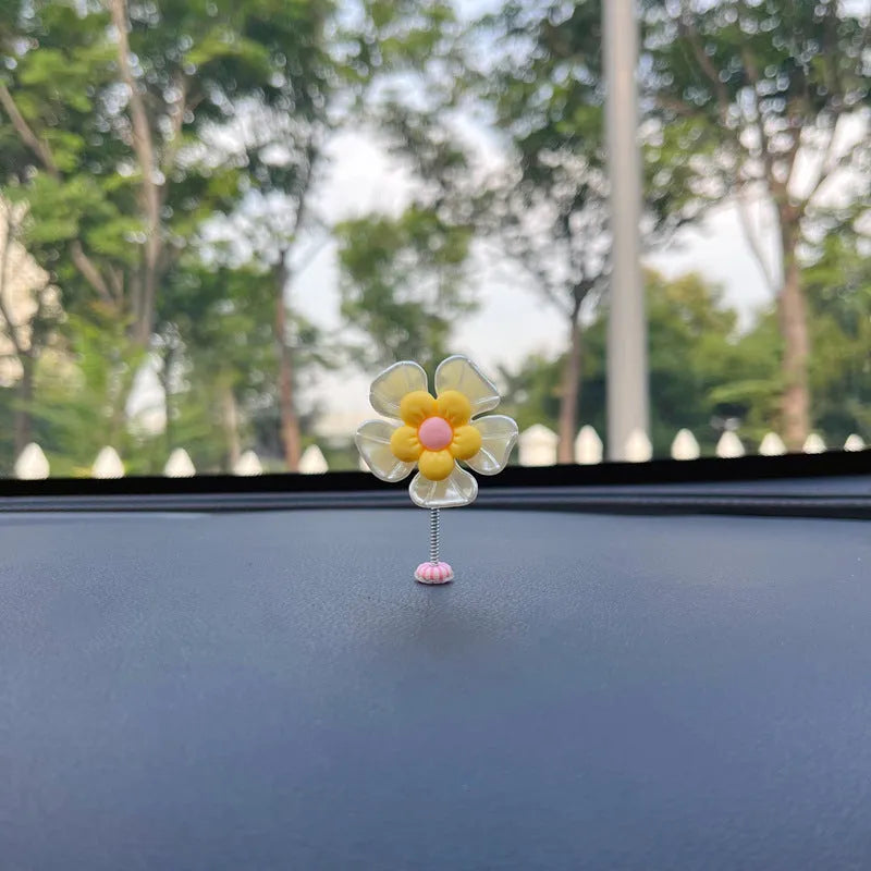 Coloured plastic car decoration swing ornament measuring approximately 5cm by 3.5cm